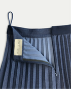 Blue pleated skirt with a brand label on a white background